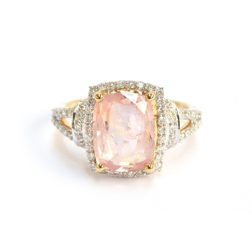 99 - An 18ct gold padparadscha sapphire and diamond ring, the cushion cut sapphire 4.7cts and measuring 1... 