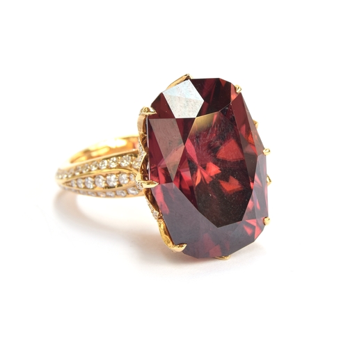 122 - A Kat Florence 18ct gold, red zircon and diamond ring, the natural red zircon 30.7cts and 20x4x14.3m... 