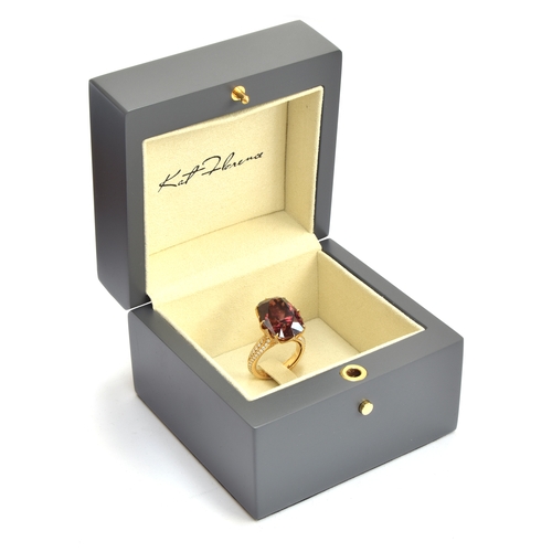 122 - A Kat Florence 18ct gold, red zircon and diamond ring, the natural red zircon 30.7cts and 20x4x14.3m... 