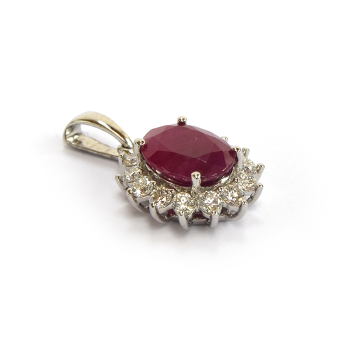 117 - A platinum mounted ruby and diamond cluster pendant, the Burmese ruby 3.25cts and 10x8mm, diamonds t... 