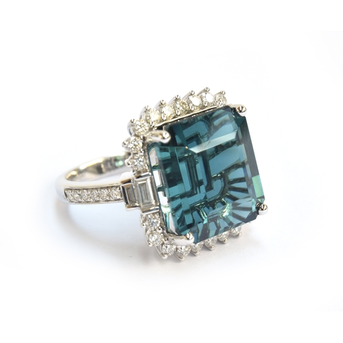 33 - An 18ct white gold, blue tourmaline and diamond cluster ring, the Monte Belo indicolite tourmaline 1... 