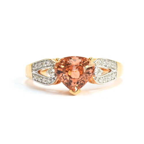 101 - An 18ct gold, peach tanzanite and diamond ring, the fancy coloured pear shaped tanzanite 1.75cts and... 