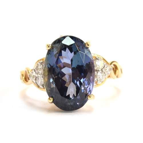 107 - An 18ct gold, chameleon tanzanite and diamond ring, the oval cut fancy chameleon tanzanite 14x9mm, g... 