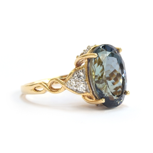 107 - An 18ct gold, chameleon tanzanite and diamond ring, the oval cut fancy chameleon tanzanite 14x9mm, g... 