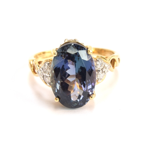 107 - An 18ct gold, chameleon tanzanite and diamond ring, the oval cut fancy chameleon tanzanite 14x9mm, g... 