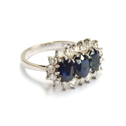 20 - An 18ct white gold mounted sapphire and diamond triple cluster ring, the diamonds totalling approx. ... 