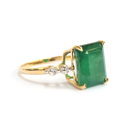 41 - An 18ct gold ring set with an emerald and white sapphires, the Bahia emerald 4.4cts and 11x8.5mm, th... 