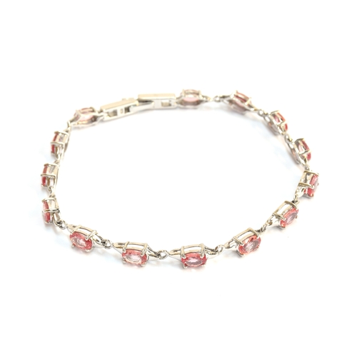 95 - A 9ct white gold and padparadscha sapphire bracelet, the sapphires totalling 6.8cts, gross weight 7.... 