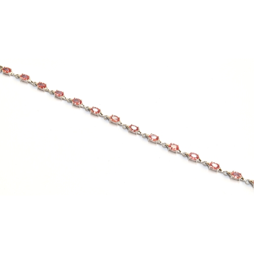 95 - A 9ct white gold and padparadscha sapphire bracelet, the sapphires totalling 6.8cts, gross weight 7.... 