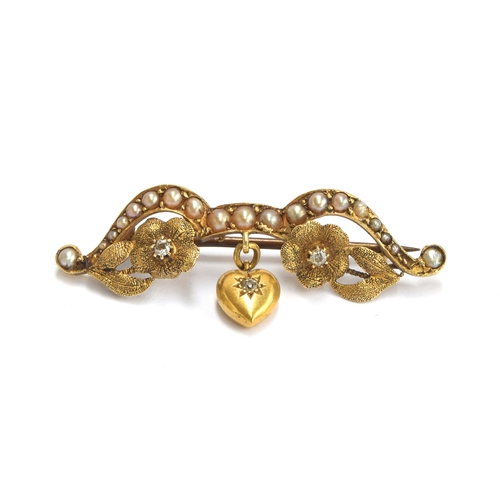 4 - A Victorian 18ct gold, diamond and seed pearl brooch in the form of a bow adorned with flowers suspe... 