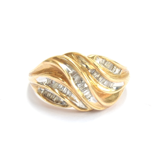 26 - An 18ct gold ring set with baguette cut diamonds in a wavy design, size M 1/2, 3.5g