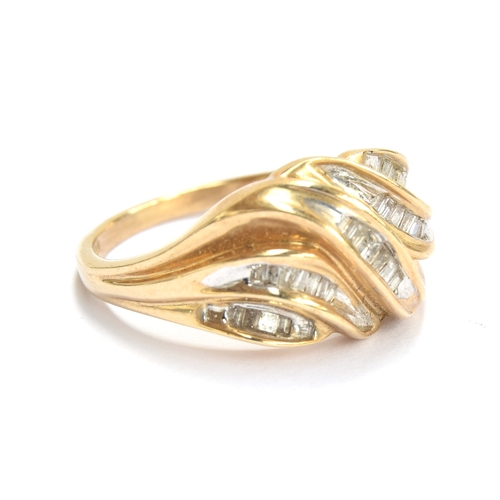 26 - An 18ct gold ring set with baguette cut diamonds in a wavy design, size M 1/2, 3.5g