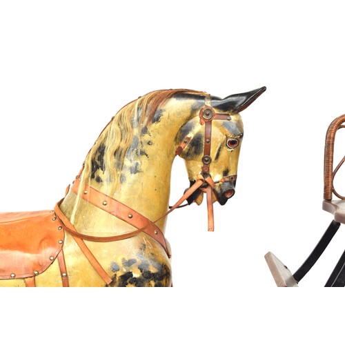 431 - A very large rocking horse, probably by F.H. Ayres, on safety stand, carved and  painted, with amber... 