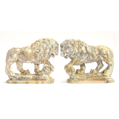 234 - A pair of carved marble sculptures in the form of Medici lions with orbs, 24cm long

Provenance: pri... 