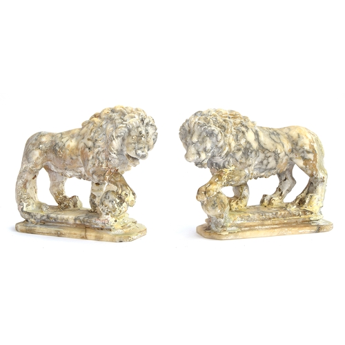 234 - A pair of carved marble sculptures in the form of Medici lions with orbs, 24cm long

Provenance: pri... 