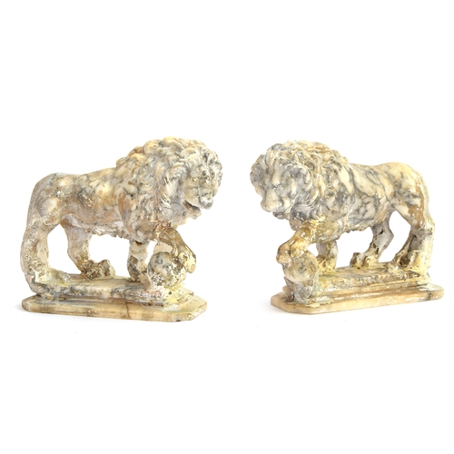 234 - A pair of carved marble sculptures in the form of Medici lions with orbs, 24cm long

Provenance: pri... 