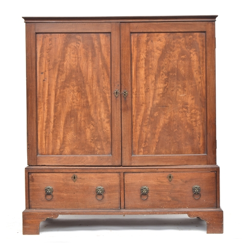 380 - A George III mahogany dwarf linen press, the panelled doors opening to four slides, over two drawers... 