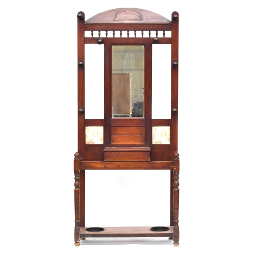 419 - A late Victorian mahogany hall stand, with mirror surrounded by eight coat hooks, two tiles inset be... 