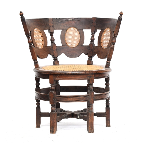 429 - An 18th/19th century Burgomaster chair, 
the back with three oval cane panels, above a circular cane... 