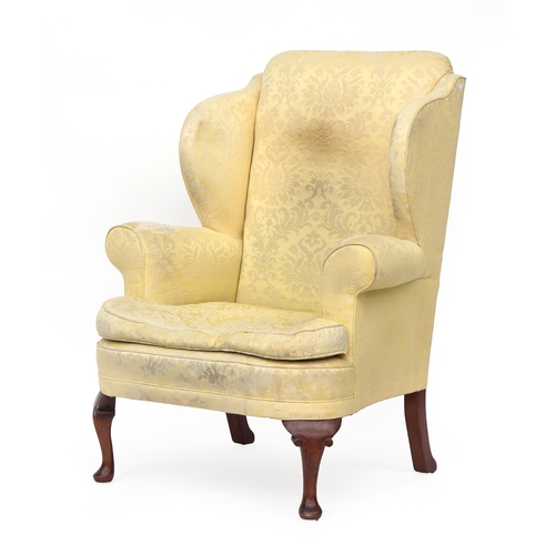 441 - A large wingback armchair in 18th century taste, with outscrolled arms, with feather filled squab cu... 