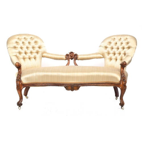 444 - A Victorian carved walnut button upholstered camelback sofa, 170cm wide