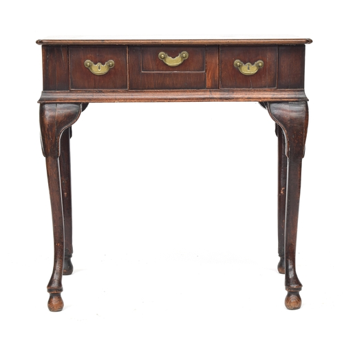 375 - A George II mahogany lowboy, the moulded top with reentrant corners, over three drawers, on carved c... 