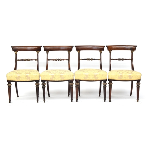 446 - A set of four rosewood and parcel gilt Regency side chairs, the curved rail on gilt anthemion capped... 