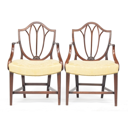 445 - A set of five George III Hepplewhite style mahogany side chairs, two carvers, the shield backs above... 