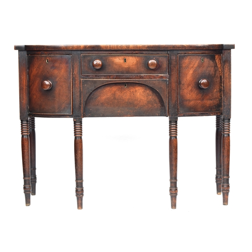 384 - A Regency mahogany bowfront sideboard, two central drawers flanked by cellarette drawers, on ring tu... 