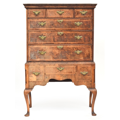 372 - A George II walnut chest on stand, the moulded cornice above three short and three graduating cross ... 