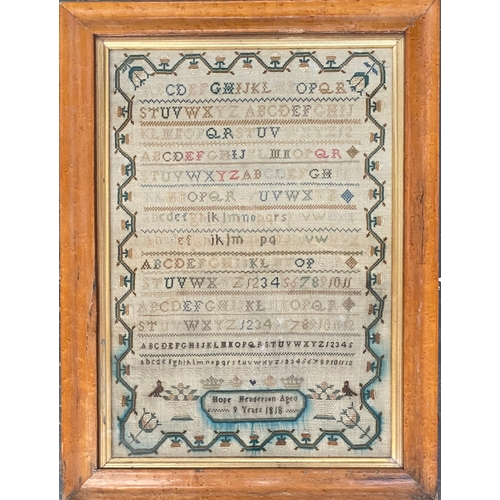 275 - A Georgian needlework alphabet sampler, worked by Hope Henderson Aged 9, 1818, with a floral border ... 