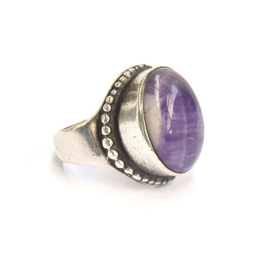 23 - Peter Guy Watson, a silver and amethyst Modernist ring, stamped PGW and hallmarked for London 1973, ... 