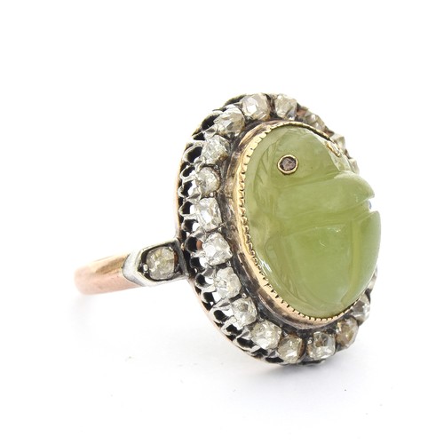 6 - A late Victorian Egyptian Revival carved jade scarab and diamond cluster ring, the carved green jade... 