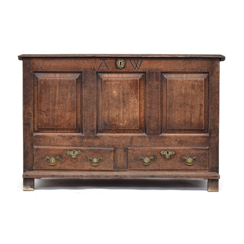 366 - An 18th century oak mule chest, inlaid with the monogram A.W, with three fielded panels over two dra... 