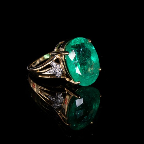 38 - An impressive 18ct gold ring set with a large Muzo Colombian emerald, the oval cut emerald 17x12mm a... 