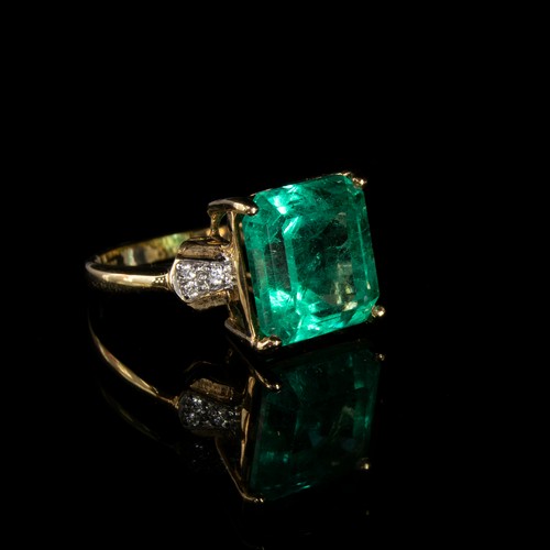 39 - An 18ct gold, emerald and diamond ring, the Muzo Colombian emerald 8.69cts and 12.5x12mm, size N 1/2... 