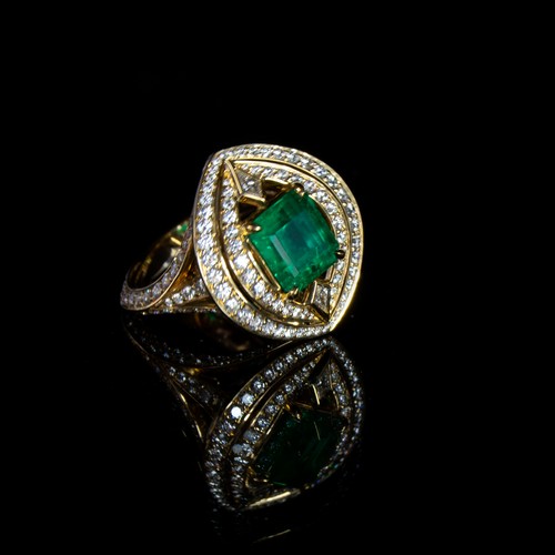 125 - A Kat Florence 18ct yellow gold, diamond and emerald ring of navette form, the Russian emerald 2.97c... 