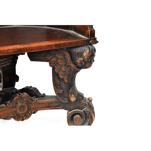 352 - A 17th century and later barrel chair, the base formed as three winged cherubs, the later seat with ... 