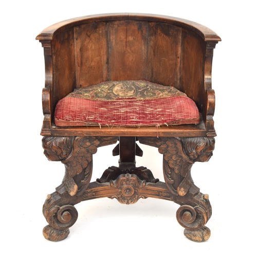 352 - A 17th century and later barrel chair, the base formed as three winged cherubs, the later seat with ... 