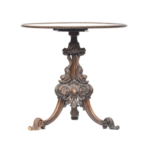 393 - An 18th century tripod table, the dished moulded top raised on a handsomely carved support formed as... 