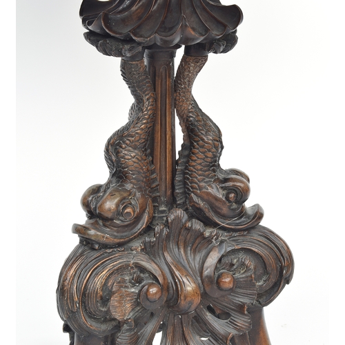 393 - An 18th century tripod table, the dished moulded top raised on a handsomely carved support formed as... 