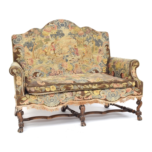 454 - A Queen Anne style two seater sofa, needlework upholstery, the shaped back over outscrolled arms, on... 