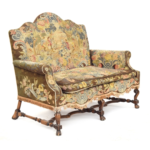 454 - A Queen Anne style two seater sofa, needlework upholstery, the shaped back over outscrolled arms, on... 