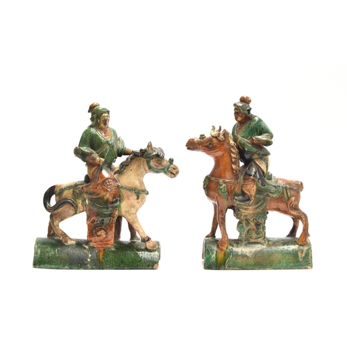 201 - A pair of Chinese Sancai glazed pottery roof tiles in the form of warriors on horseback, 32cm high a... 