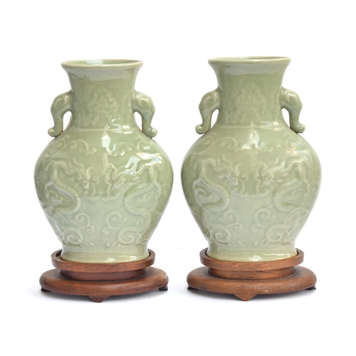 202 - A pair of Chinese Longquan celadon glaze dragon vases with twin Elephant lug handles, 27cm high, 19.... 