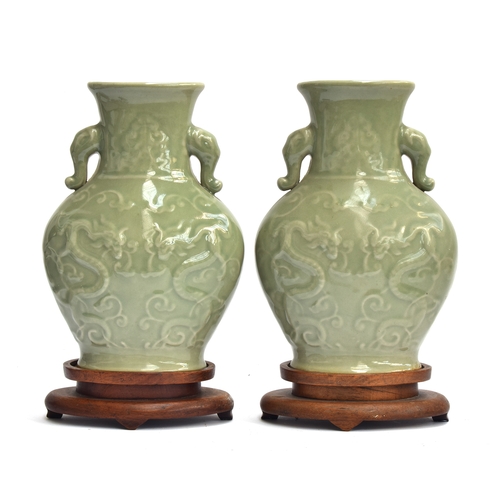 202 - A pair of Chinese Longquan celadon glaze dragon vases with twin Elephant lug handles, 27cm high, 19.... 