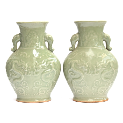 202 - A pair of Chinese Longquan celadon glaze dragon vases with twin Elephant lug handles, 27cm high, 19.... 