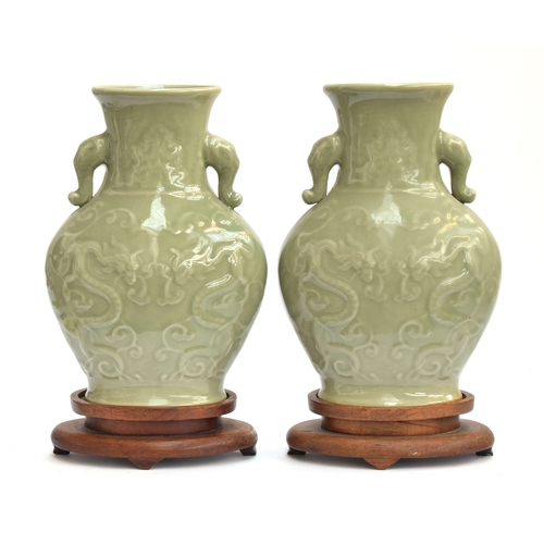 202 - A pair of Chinese Longquan celadon glaze dragon vases with twin Elephant lug handles, 27cm high, 19.... 