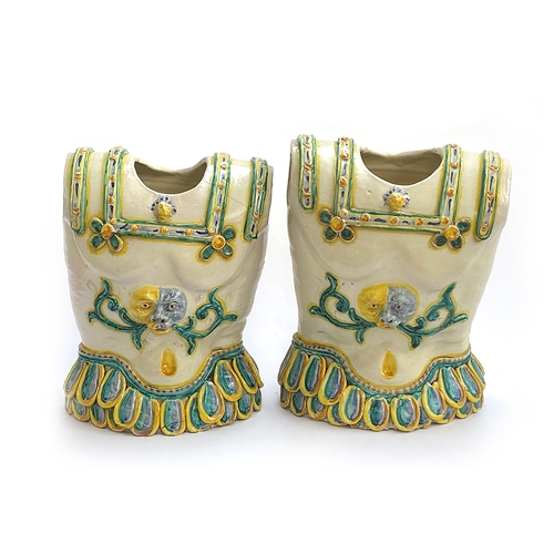 105 - A pair of Italian Caltagirone majolica jardinieres in the form of breastplates, in Renaissance style... 