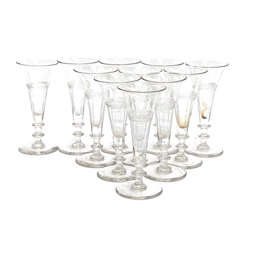 132 - A set of 11 hand blown trumpet flute glasses, with knopped stems, 15cmH